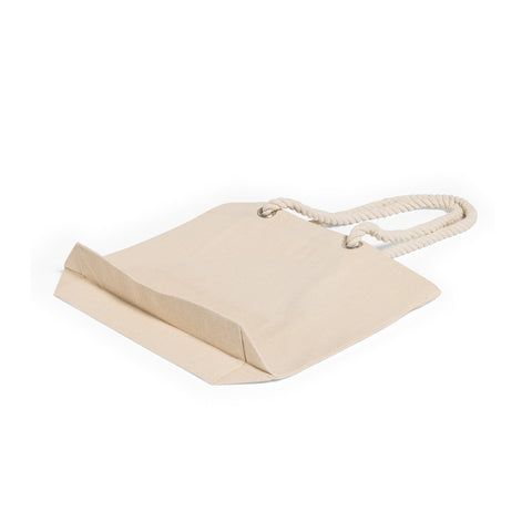 Structured rope-bottom tote bag with canvas body standing on a wooden floor
