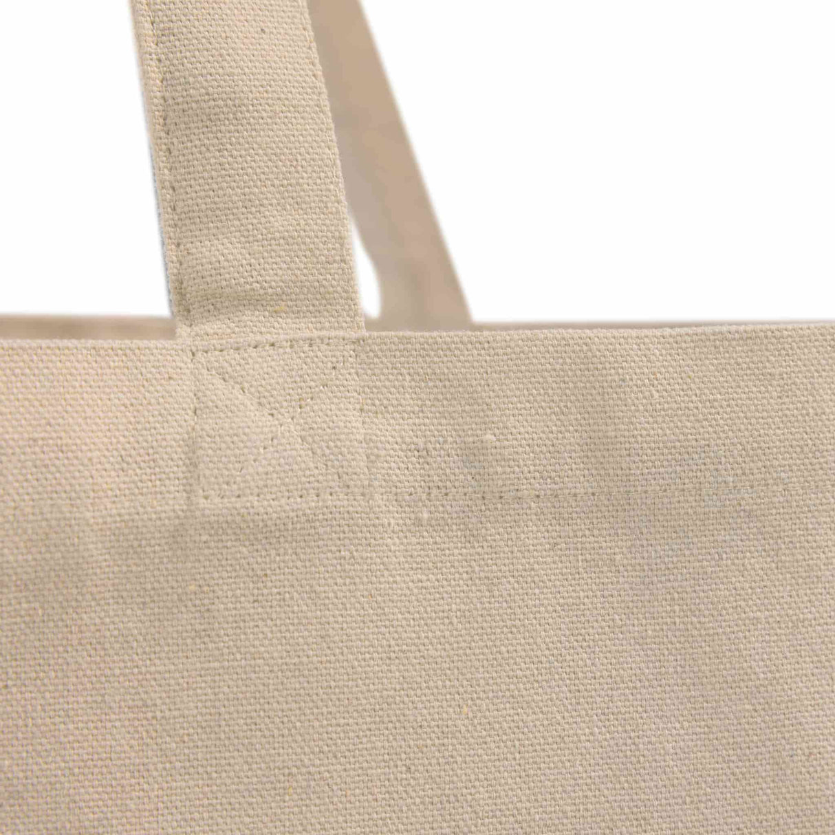 Close-up detail of the Recycled Trader's Canvas Tote's reinforced self-fabric handles for added strength and durability.