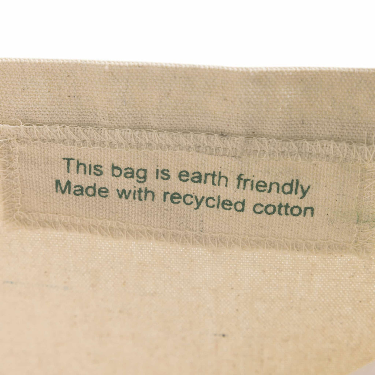 Interior view of the Recycled Trader's Canvas Tote with a sewn-in eco-friendly label, indicating recycled cotton material.